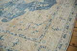 Distressed blue and sand patterns on a vintage Sparta rug, showing even wear to knot heads.