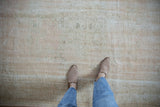 Distressed vintage Oushak rug pile with mostly even wear and exposed foundation.