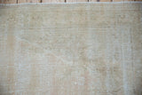 Textured pile of distressed vintage Oushak rug with wear to knot heads and foundation.