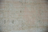 Distressed Oushak rug detail showing mostly even wear, foundation, and pale beige tones.