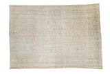 Distressed vintage Oushak carpet with faded cream and pale sage tones, measuring 6'4