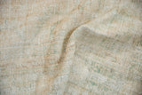 Textured distressed Oushak rug surface with cream, ivory, and pale sage worn hand-knots.