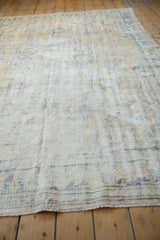 Distressed Oushak carpet: low pile texture, visible foundation, cream, and faded denim blue.