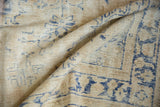 Storied wear and visible foundation texture on the beige Oushak rug with soft blue patterns.