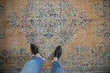 Time-softened apricot, cobalt, and ivory medallion design on this vintage Oushak carpet.