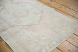 Textured pile of the vintage distressed Oushak runner with faint geometric motifs and even wear.