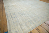 Distressed Oushak surface, showing foundation through muted beige and dusty blue.