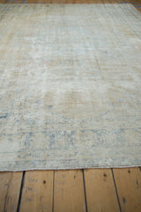 Vintage Distressed Oushak rug's worn texture, exposed foundation, and dusty blue motifs.