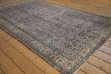 Distressed Oushak carpet with scrolling vine pattern, even wear, dusty aubergine and sea foam.