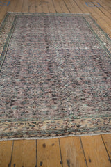 Vintage distressed Oushak rug texture with dusty aubergine and sea foam green vine motifs.
