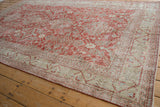 Textured brick red field with oversized palmettes and geometric vine border on a vintage Sivas rug.