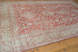 Distressed brick red floral motifs and beige geometric border on this vintage Sivas carpet.