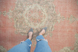 Distressed Turkish Sparta vintage carpet with soft rose, ivory, and silver floral patterns, showing even wear.