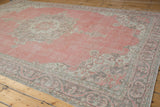 Distressed rose field, silver palmette motifs on the Sparta rug's border.