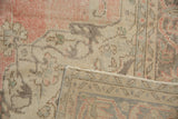 Worn rose and ivory pile of Distressed Sparta rug, faint foundation, geometric reverse.
