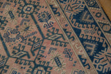 Distressed Melas rug detail, dusty rose field with indigo geometric vinery and even pile wear.
