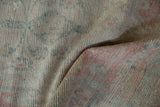 Distressed Oushak runner pile featuring soft ivory, blush, and ocean green tones.