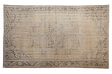 Distressed beige Oushak carpet with faded charcoal vinery, floral medallion, and border, 6'1