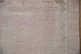 Even wear across the knot heads and faint foundation of a distressed Turkish Oushak rug.