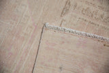 Corner detail showing the hand-knotted back and secured selvage of an Oushak runner.