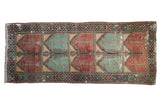 Vintage distressed Oushak runner with a tree of life design in alternating red, mint green, and gold panels.