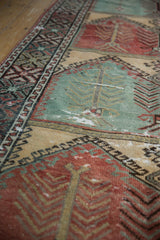Angled view of the distressed runner's worn texture over its tree of life motif panels.