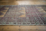 Vintage Distressed Oushak runner's serrated leaf border with starburst motifs in soft aubergine and mint.