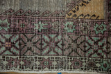 Distressed Oushak runner border details: aubergine, mint green, oxidized silver patterns.