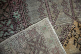 Distressed Oushak pile in aubergine and oxidized silver over hand-knotted foundation.