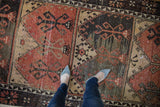 Detail of vintage distressed Oushak runner with simplistic scrolling tree of life motifs.