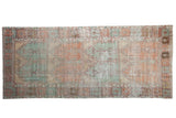 Vintage distressed Oushak rug runner with a multi-panel geometric design in mint green, burnt orange, and ivory.