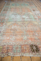 Angled perspective of the vintage Oushak runner showing the pattern flow and distressed texture.