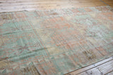 Hand-knotted texture of a distressed Oushak rug with low pile showing mostly even wear.