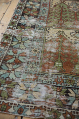 Angled view of a distressed Oushak runner's texture, highlighting the worn pile and visible foundation.