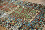 Storied wear over geometric panels and a starburst floral border on a vintage Oushak runner.
