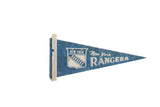 Vintage 1960s New York Rangers felt pennant in blue and white, 5x10 inches.