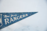 Vintage New York Rangers blue felt pennant, detail of white 'Rangers' text on the pointed tip.