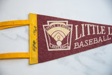 Detail of Little League felt pennant, yellow border with black markered 1962 date.