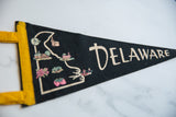 Black felt vintage Delaware pennant with pastel pink and blue graphic details.