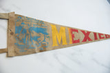 Vintage Mexico suede pennant with painted yellow and red 'MEXICO' letters and bull graphic.