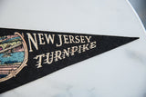 Vintage New Jersey Turnpike felt pennant with cream lettering and bridge graphic.