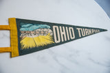 Angled view highlighting the mid-century toll booth graphic on the felt pennant.
