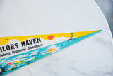 Vintage Sailors Haven felt pennant tip with yellow sky, sun, and sailboat.