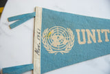 Robins egg blue felt texture featuring cream United Nations logo with oxidation.