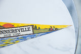 Illustrated tipis and trees on the yellow felt tip of the vintage Tannersville pennant.