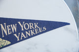 Vintage blue felt pennant with 'YORK YANKEE' lettering at its pointed end.