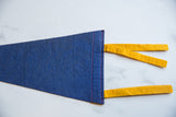 Deep blue felt pennant end with bright red stitching and yellow ties.