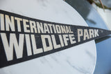 Vintage International Wildlife Park felt pennant showing aged white lettering on black.