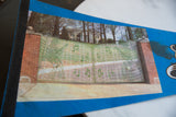 Vintage Graceland felt pennant detail: black stitched edge, blue felt, and brick gate section.