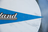 Vintage Graceland blue felt pennant's pointed tip with noticeable wear.